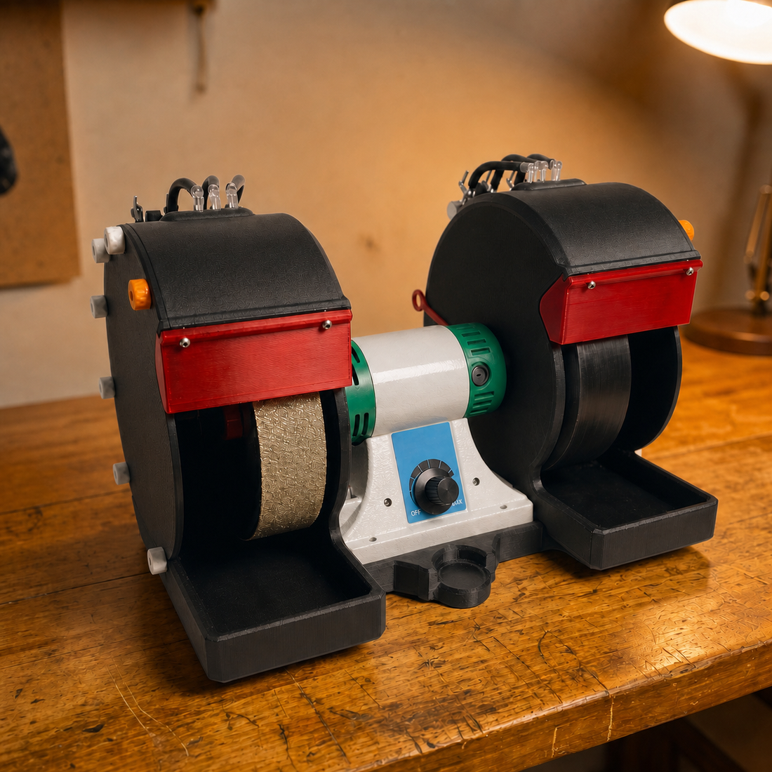 Aetherium Cut 'n Cab v2 Carbon Pro cabbing machine at rest with twin guarded wheels, water trays, and central variable-speed motor on a worn workshop bench.