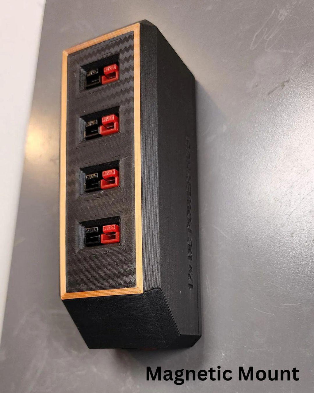 Carbon Fiber Face PatternClose-up of the DC power splitter showing four red Anderson Powerpole connectors aligned vertically in a matte black rectangular housing. The product is designed for 12V and 24V DC systems.