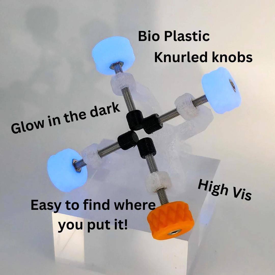 Gem Axis V3 with glowing blue TPU knobs and a high-visibility orange knob, designed to be easy to find at the bench. Lightweight lapidary alignment jig made from bioplastic and steel hardware for faceting and cabbing workflows.