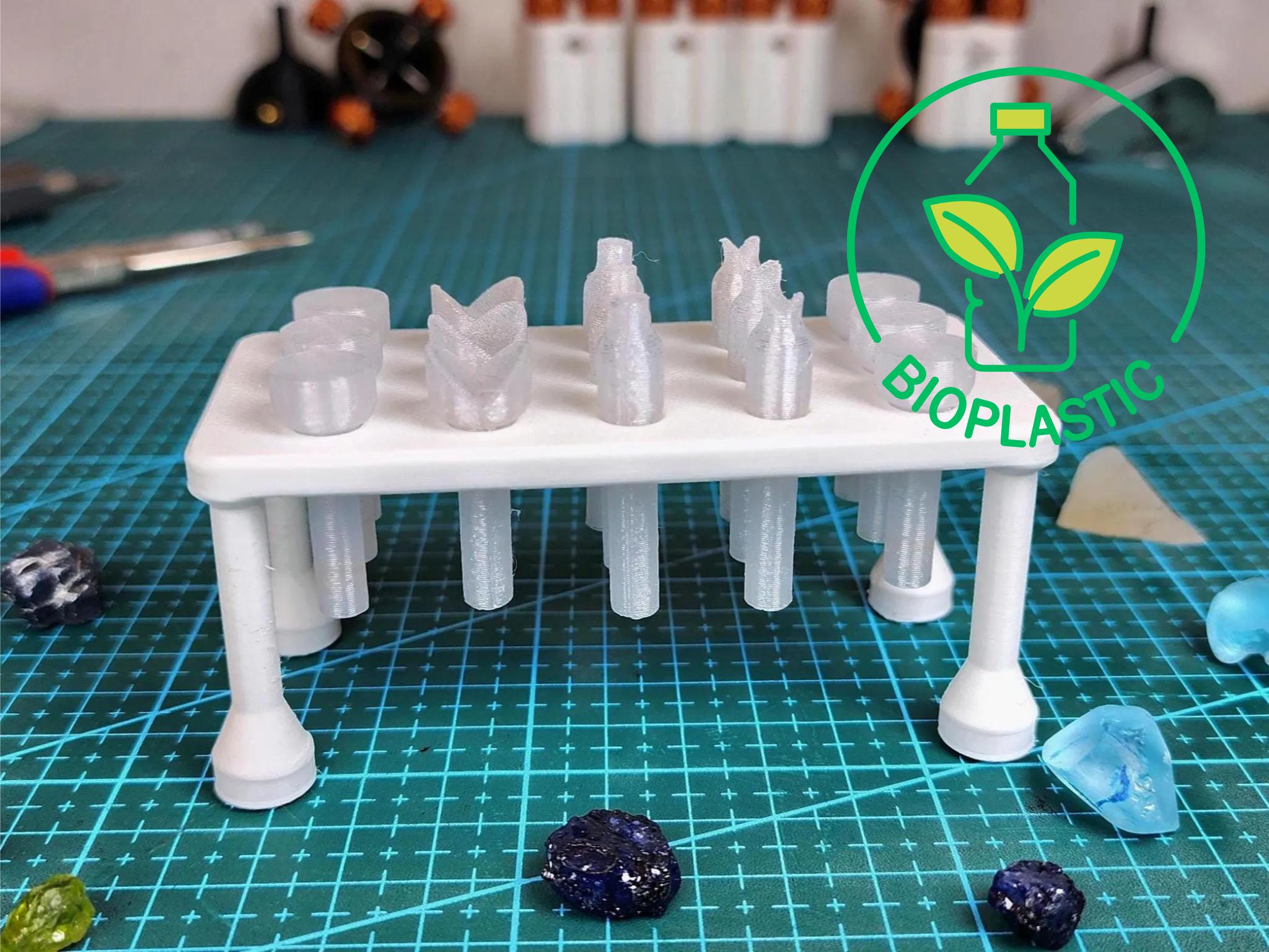 White bioplastic magnetic dop tray shown empty with multiple dop holes and raised feet. Embedded magnets provide secure attachment to metal surfaces. Designed for 6 mm dop sticks used in faceting and cabochon cutting workflows.