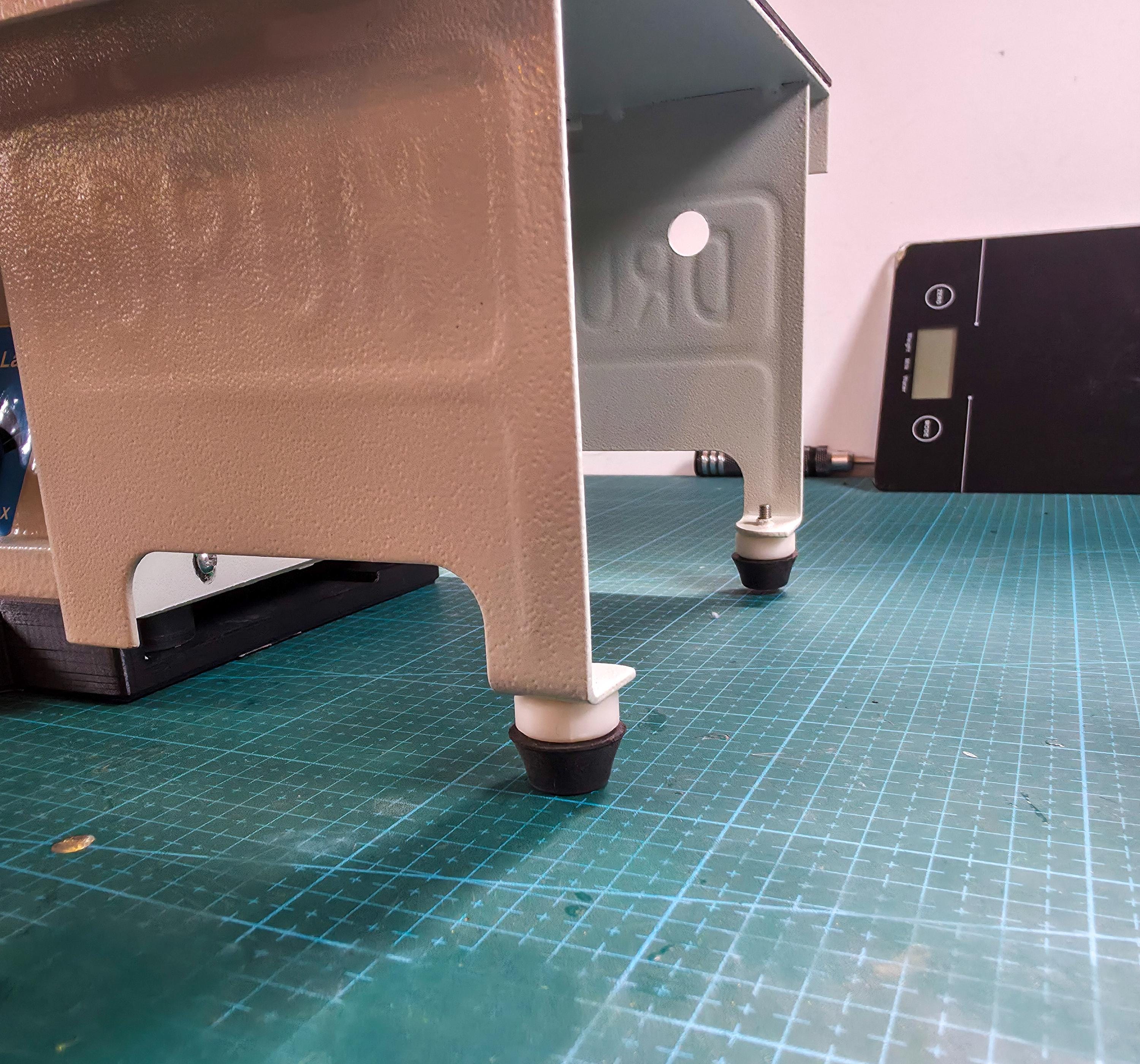 Underside detail of lathe stand showing added leveling feet used with the adapter plate for balanced setup on uneven work surfaces.