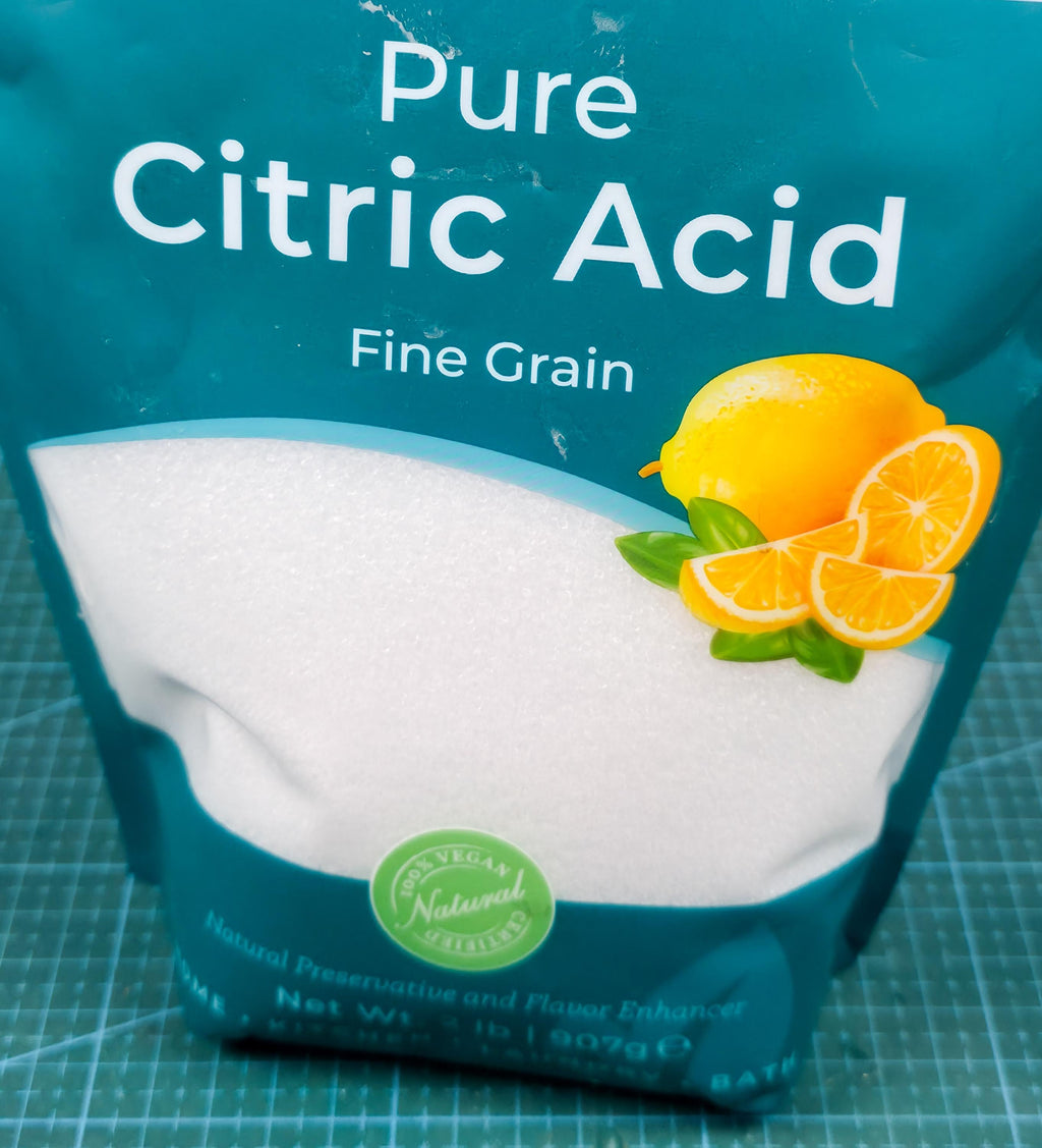 image includes a bag of pure fine grain citric acid with a lemon decal. natural product