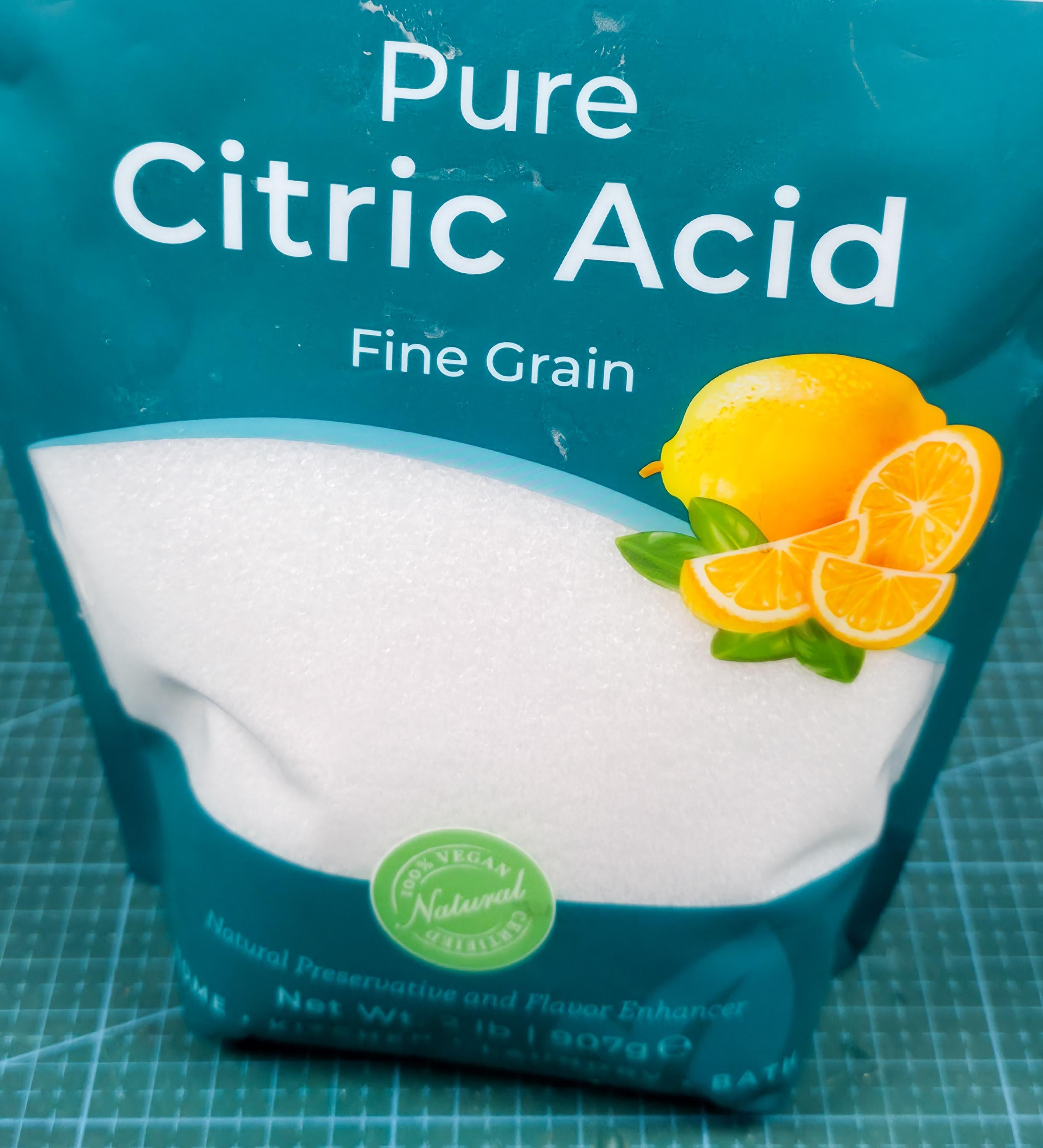image includes a bag of pure fine grain citric acid with a lemon decal. natural product
