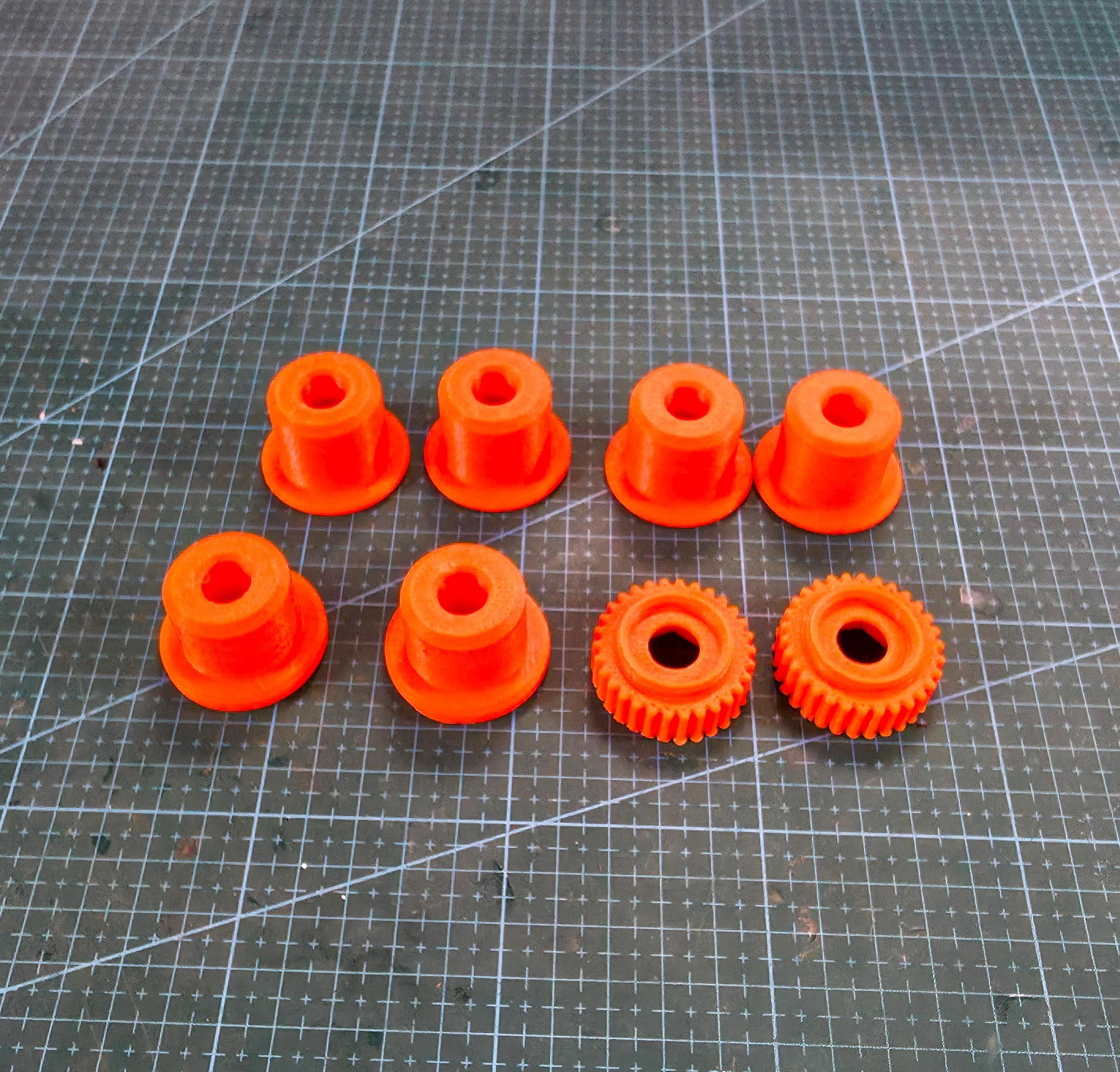 Image features high vis colored wheel spacer adapters and nut screws printed out of GF-ABS on a cut resistant mat. Highlighting the intended use to be installed in the abrasive wheels of your choosing.