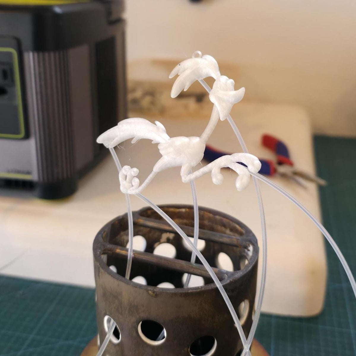 Image features a wax 3d printed roadrunner with pvb filment attached to it to be prepared for lost wax jewelry casting a pendant for a personalized pendant through the Aetherium Jewelry Service.