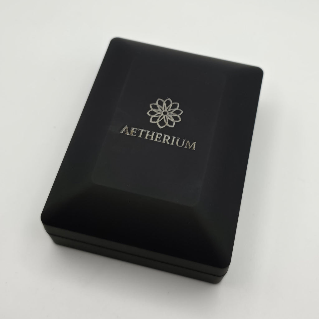 Closed black jewelry box featuring engraved silver Aetherium logo on the lid. Matte black finish provides elegant, modern presentation. Box doubles as protective case and luxury packaging, reinforcing the pendant’s premium gifting quality for anniversaries, weddings, and romantic milestones.