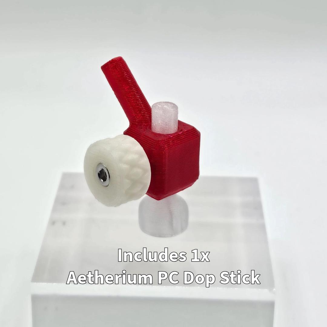 Aetherium 45-degree lapidary tabling adapter displayed on a white pedestal, showing the red polymer body, white adjustment wheel, and included clear polycarbonate dop stick. The compact fixture holds a gemstone dop at a fixed angle for cutting flat tables, leveling cabochon backs, or polishing windows on faceting machines that use 6 mm dop systems.
