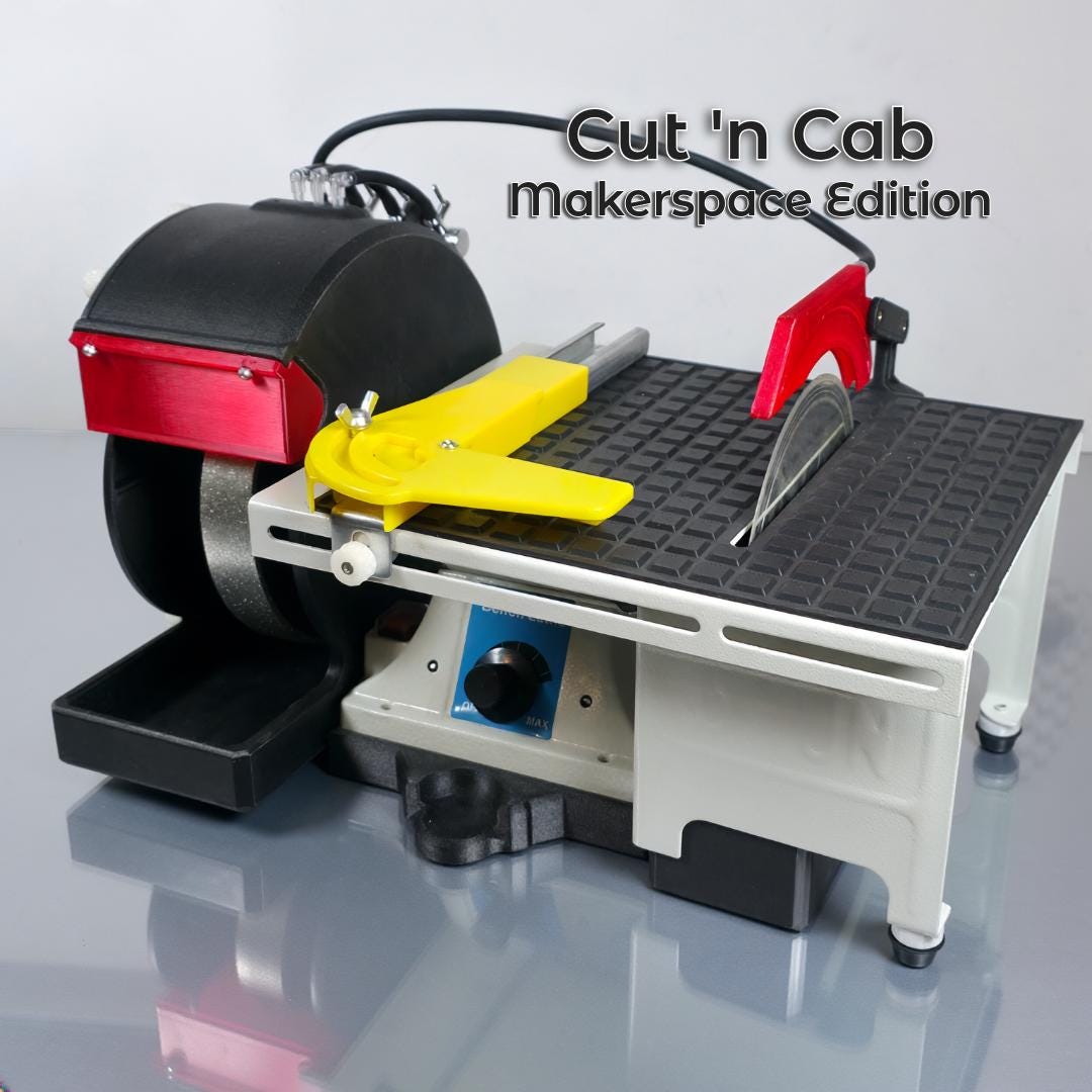 Hero image showing the Cut ’n Cab – Makerspace Edition, a compact lapidary machine featuring a black grinding wheel, red blade guard, yellow miter guide, and gray modular base. The tool sits on a reflective gray surface against a light background. Clean typography in the top right reads “Cut ’n Cab Makerspace Edition.” The photo highlights industrial precision, sturdy construction, and workshop-ready design ideal for makers and jewelry artists