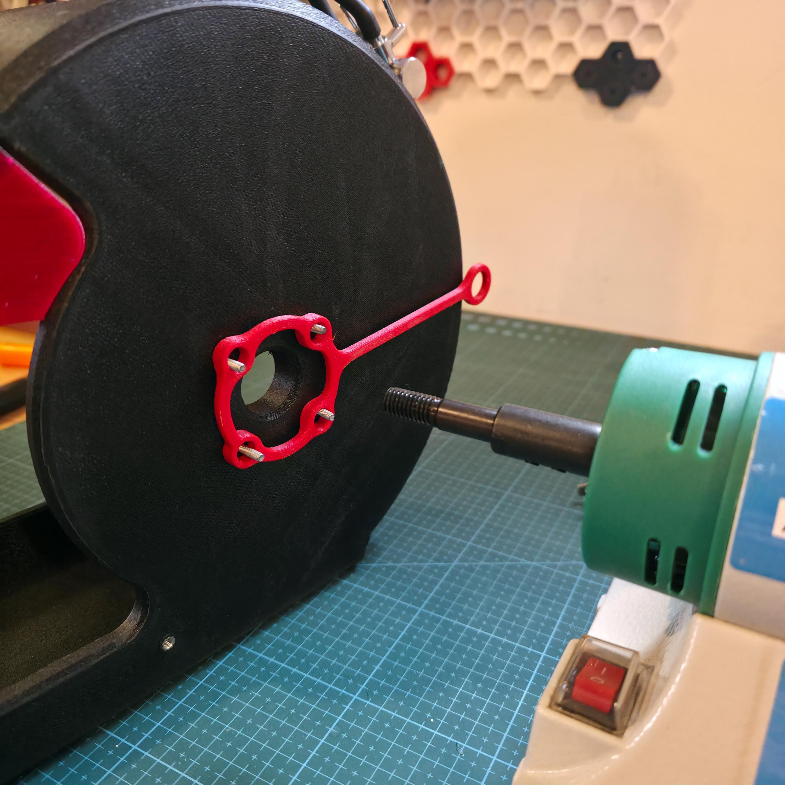 Close-up of the red spacer set mounted onto the black wheel housing of the MakerSpace Edition. The photo highlights modular fasteners and carbon-fiber composite texture. Demonstrates the new linked spacer system designed for secure assembly and faster maintenance.