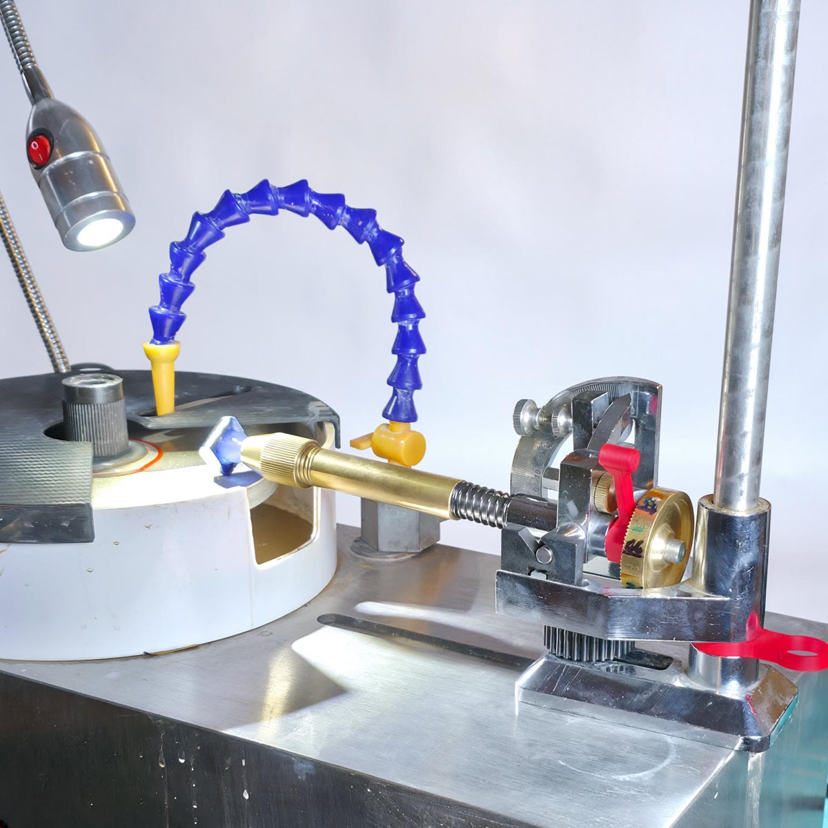 Image features the vevor faceting machine outfitted with the aetherium upgrade kit. A blue gemstone is being leveled off using the spacers.