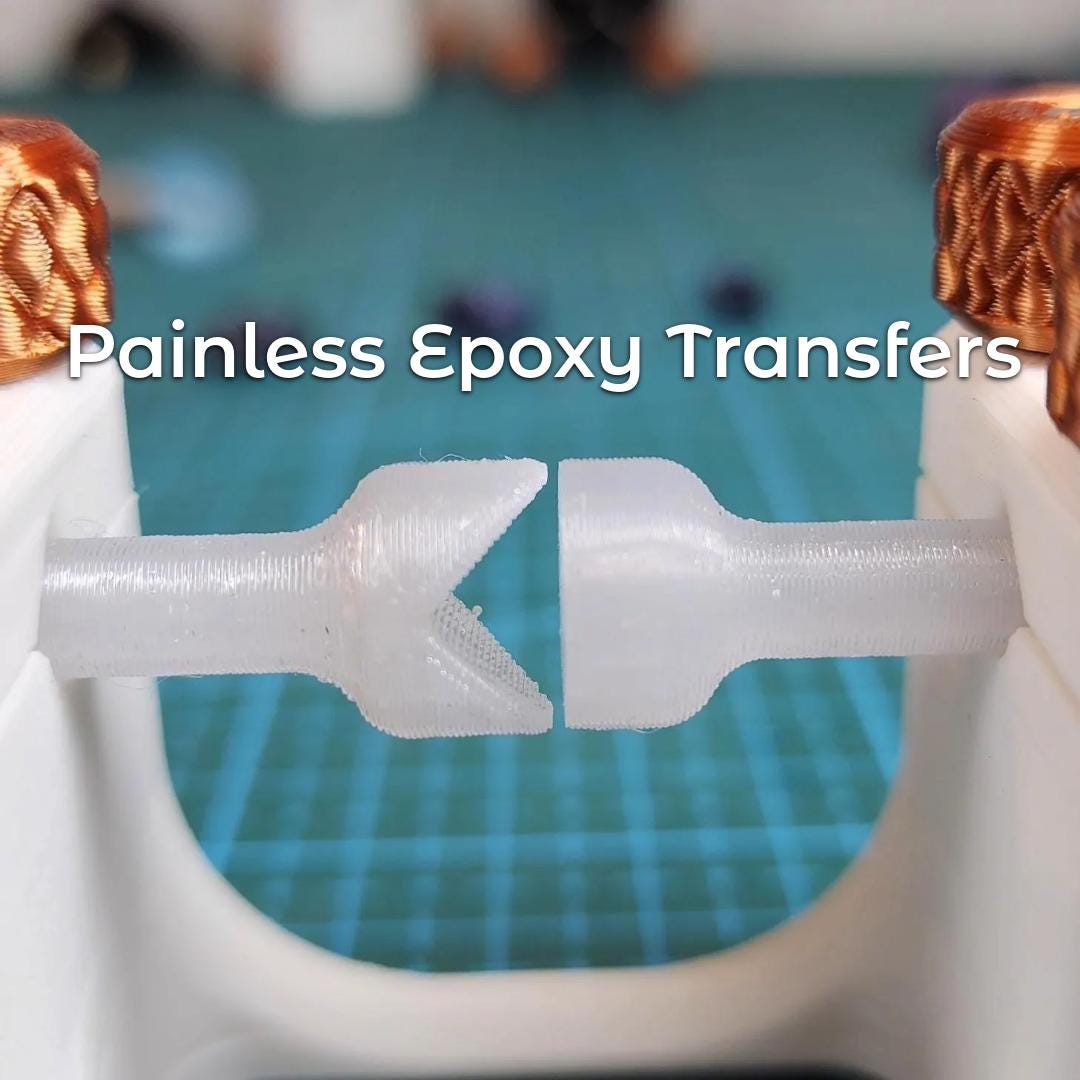 "A close-up of two transparent dop sticks aligned within the Gem Xfer jig, positioned tip-to-tip for precise epoxy transfer. The text overlay reads 'Painless Epoxy Transfers.' Orange textured knobs adjust pressure while the translucent design emphasizes accuracy and control in lapidary workflow."