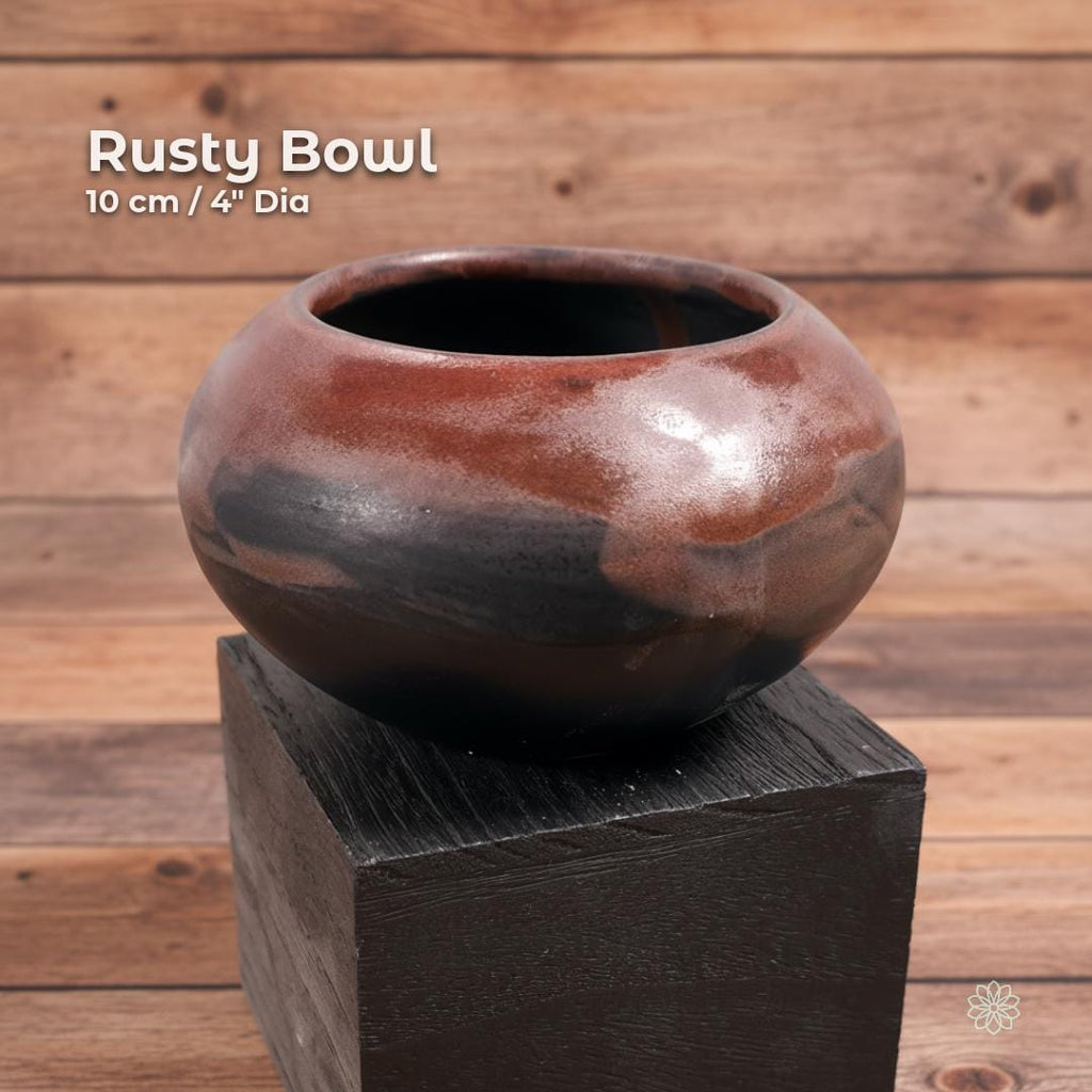 “Brown and black reactive-glaze ceramic altar bowl shown on a black display block. On-image text reads ‘Rusty Bowl’ and ‘10 cm / 4" Dia.’ Handmade rounded stoneware with deep interior.”