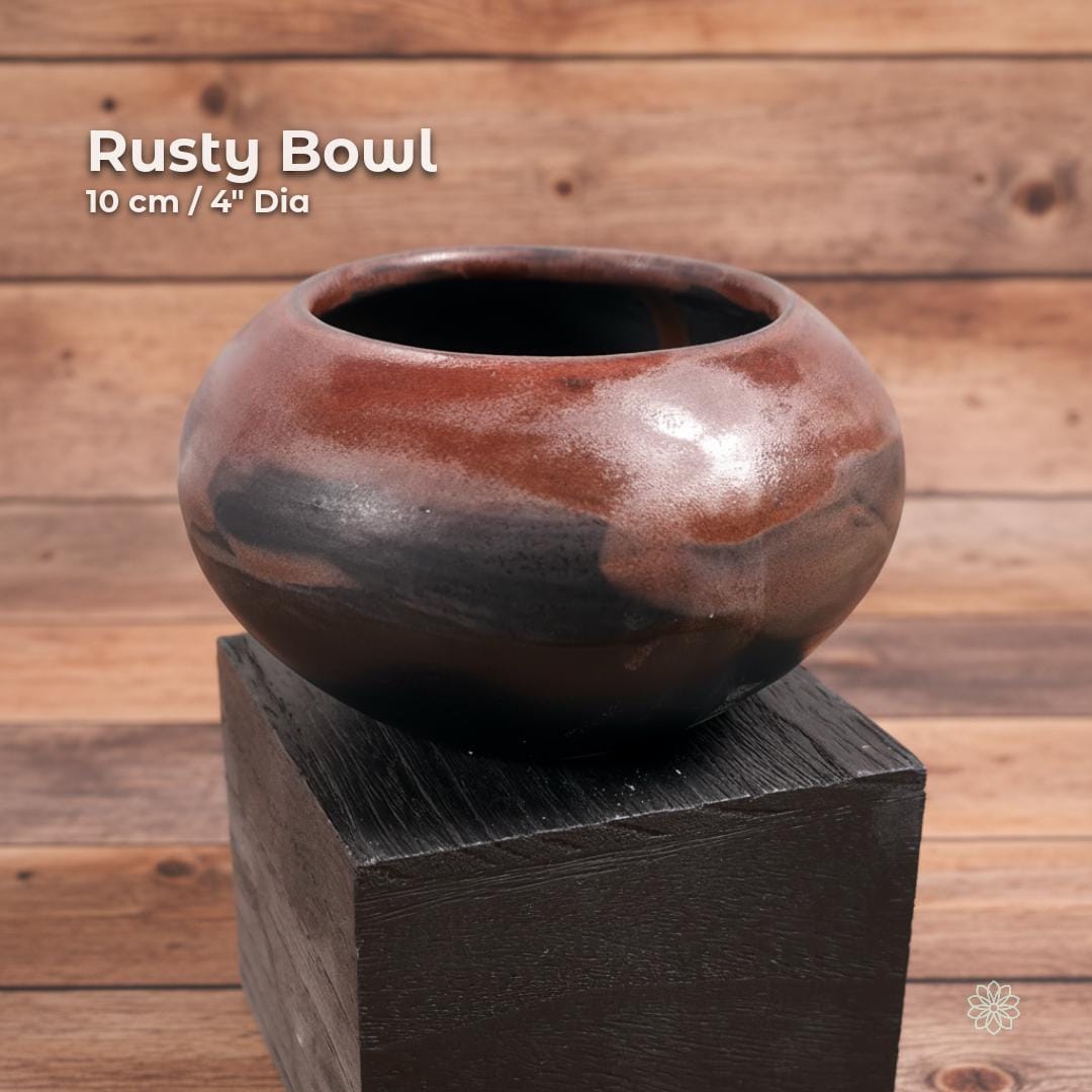 “Brown and black reactive-glaze ceramic altar bowl shown on a black display block. On-image text reads ‘Rusty Bowl’ and ‘10 cm / 4" Dia.’ Handmade rounded stoneware with deep interior.”