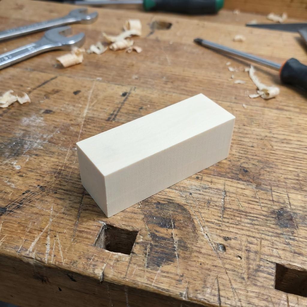 A compact epoxy machining block with sharp edges and a consistent matte finish — alternate view 2