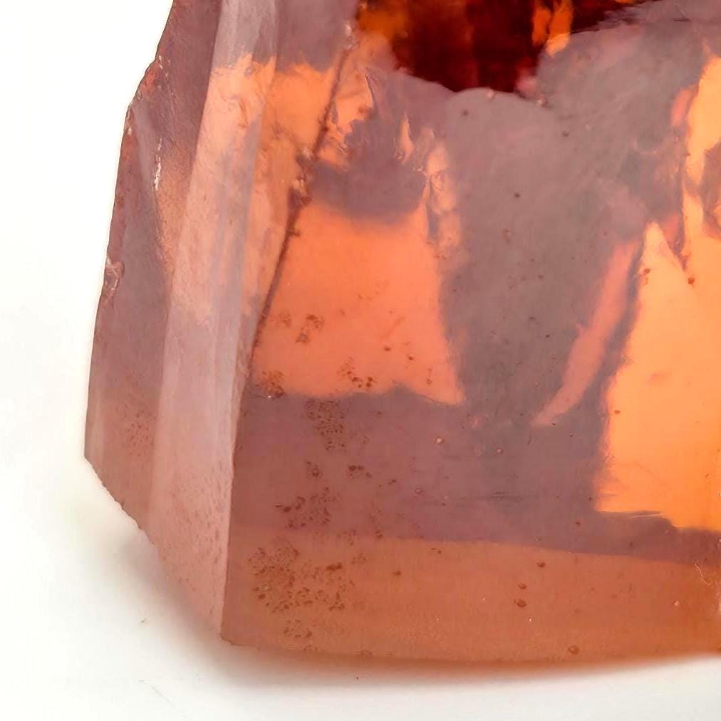 “Lower portion of champagne CZ rough showing internal clarity, amber tone, and small natural inclusions. Ideal for cutters producing matched stones, practice cuts, or jewelry prototypes.”