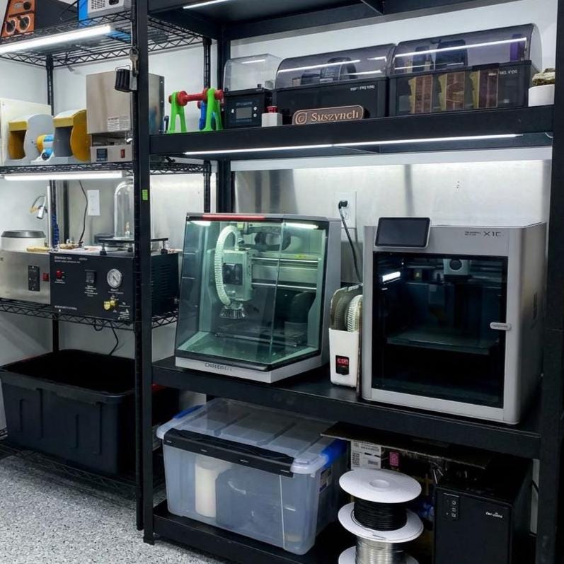 “Wide view of workshop shelving filled with fabrication tools, including a Carvera Air CNC, Bambu X1C 3D printer, casting machines, and filament spools. Highlights the full professional workspace used for rapid prototyping and custom part fabrication.”