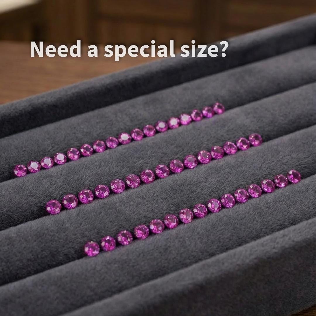 Rows of lab grown pink sapphire stones, 2 mm round cut, displayed in a jewelry tray. Even sizing and color consistency shown for production jewelry use, including wedding bands, custom rings, and detailed accent layouts.