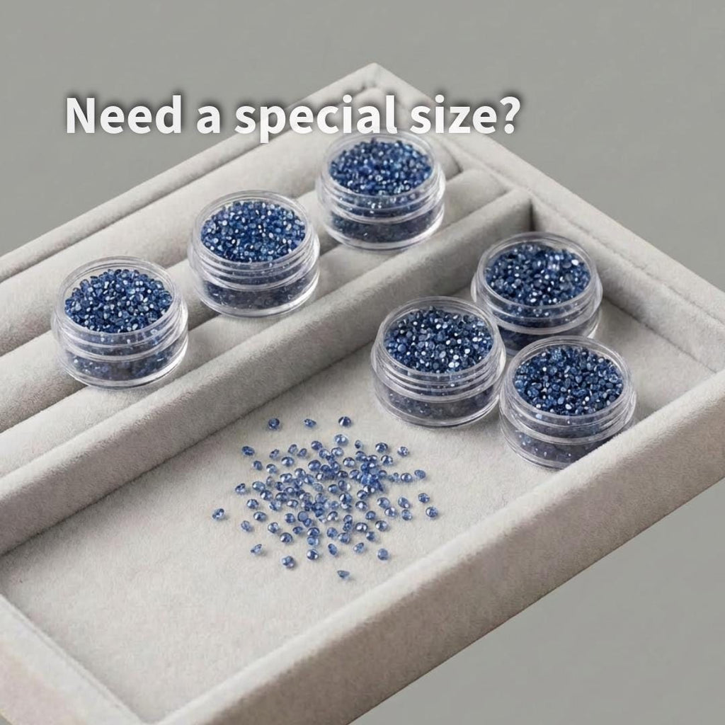 Multiple containers filled with 1 mm lab-grown blue sapphire accent stones displayed in a jewelry tray. Loose round brilliant sapphires shown as bulk supply for jewelers, setters, and small stone production runs.