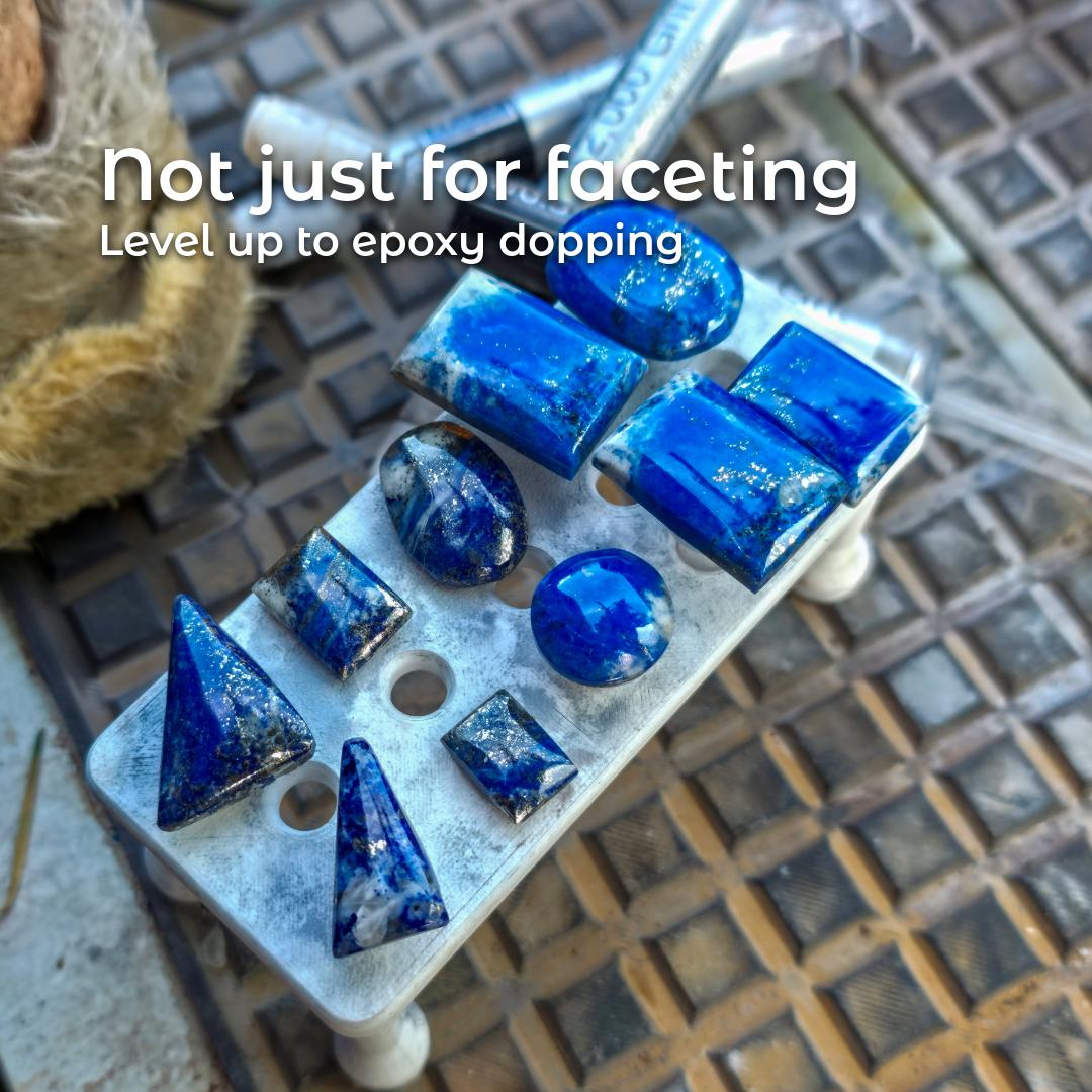 Epoxy-dopped cabochons arranged on a dop board, including lapis lazuli pieces in various shapes. Text reads “Not just for faceting – Level up to epoxy dopping,” highlighting the dop stick versatility for cabbing, carving, and adhesive-based stone setting.