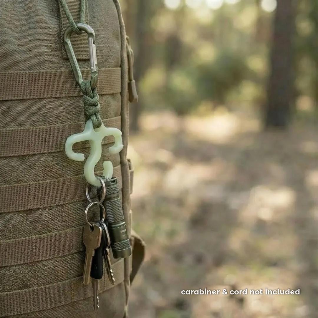 Mini bioplastic paracord hook attached to a tactical backpack using paracord and a small carabiner. Keys and a flashlight hang from the hook, showing its use as an ultralight EDC organizer for hiking or everyday carry. carabiner not included.