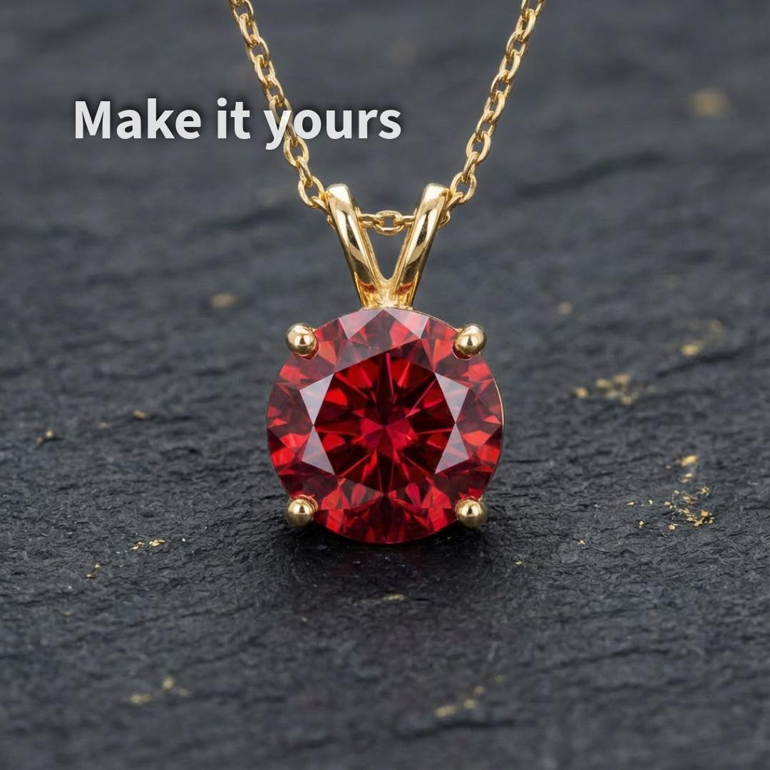 Ruby moissanite gemstone shown set in a gold pendant to demonstrate scale and jewelry potential. The 1 ct round Russian brilliant cut stone exhibits deep red color and strong sparkle. Image illustrates how this loose gemstone can be transformed into a finished custom necklace or heirloom piece.