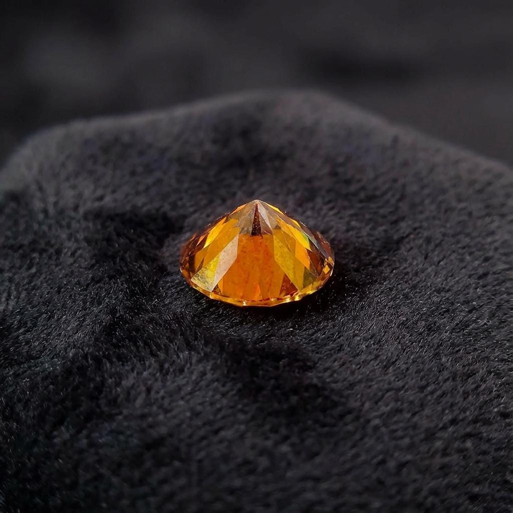 Side profile view of a round ruby moissanite gemstone showing crown height and precision Russian brilliant faceting. The stone’s cut supports strong light return and clean symmetry, making it ideal for jewelers seeking reliable performance in fine settings or custom designs.