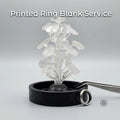 Clear PolyCast PVB 3D printed ring blanks arranged on a sprue tree, standing upright in a black casting base