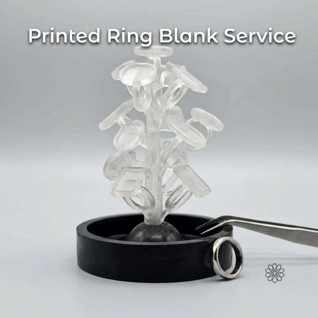 Clear PolyCast PVB 3D printed ring blanks arranged on a sprue tree, standing upright in a black casting base