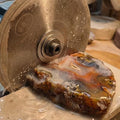 The 6" sintered diamond saw blade sawing through a thick slab of lapidary agate. Perfect for making slabs and other preforms prior to cabbing or faceting. The sintered diamond surface, holds an edge longer than thinner electroplated gemstone blades.
