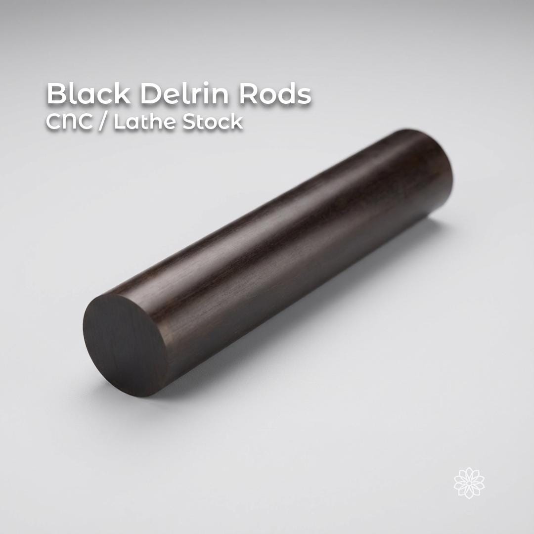 Black Delrin acetal rod shown on a clean white background, labeled CNC and lathe stock. Solid round engineering plastic rod with smooth surface finish, used for machining bushings, spacers, fixtures, and low-friction mechanical parts on CNC mills or lathes.