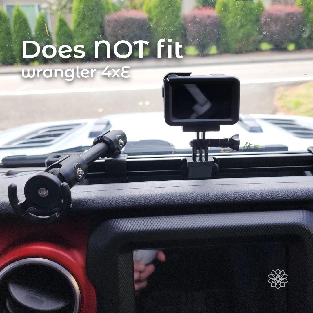 Dash accessory rail installed on a Jeep dashboard with a note indicating incompatibility with the Wrangler 4xE model. The image shows the rail mounted in the dash recess with an action camera attached, clearly demonstrating the mounting location while communicating that this configuration does not fit hybrid Wrangler dashboards.