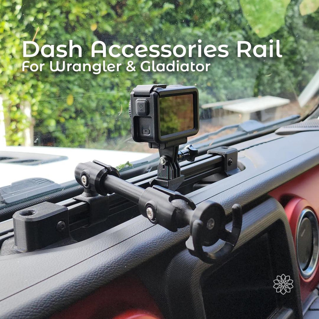 Dash-mounted accessory rail installed on a Jeep Gladiator dashboard, featuring a black aluminum extrusion rail secured with custom carbon fiber–reinforced 3D printed brackets. An action camera is mounted on an adjustable arm above the dash, with a phone ball mount visible. The rail sits flush in the factory dash recess and provides stable mounting for driving and off-road use.