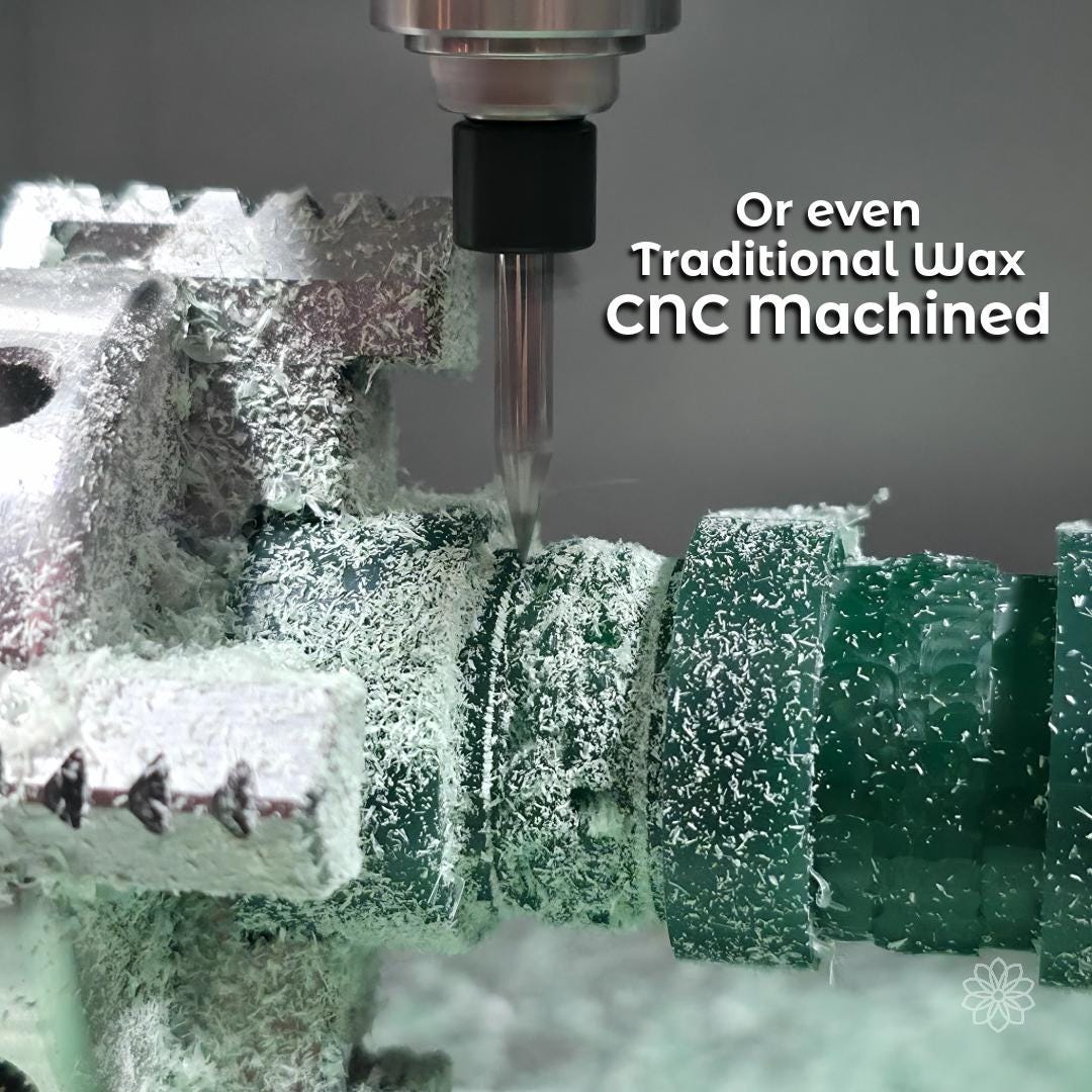 A CNC machine cutting green jewelry carving wax, with a small end mill actively machining ring forms from a wax block. Fine wax shavings surround the work area, showing subtractive fabrication used to create traditional wax patterns for metal casting when geometry or foundry workflows require conventional methods.