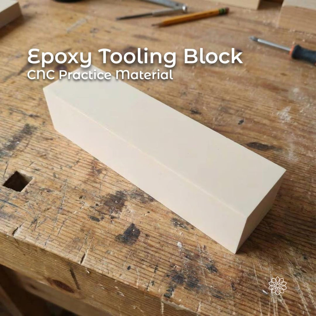 “A rectangular epoxy tooling block sitting on a woodworking bench. The block has a smooth, uniform surface and sharp machine-cut edges, showing its use as a rigid fixture material for CNC machining, prototyping, and precision modeling. Tools and wood shavings surround the block in a workshop setting. Text highlighting that this is ideal for CNC practice cuts”
