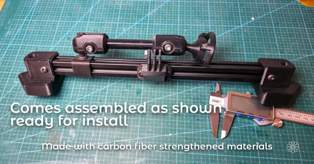 Fully assembled dash accessory rail kit displayed on a workbench, including the aluminum extrusion rail, printed mounting blocks, adjustable arm, phone mount, and action camera mount. A digital caliper is visible for scale, showing the complete system arrives assembled and ready for vehicle installation.