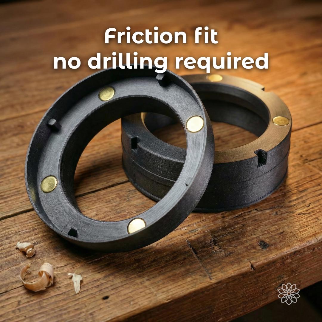 Two-piece Mag-Link magnetic diesel heater adapter shown on a wooden surface, displaying embedded magnets and friction-fit design. The components allow tool-free attachment without drilling, providing a clean interface for quickly connecting or removing heater ducting in mobile and off-grid heating systems.