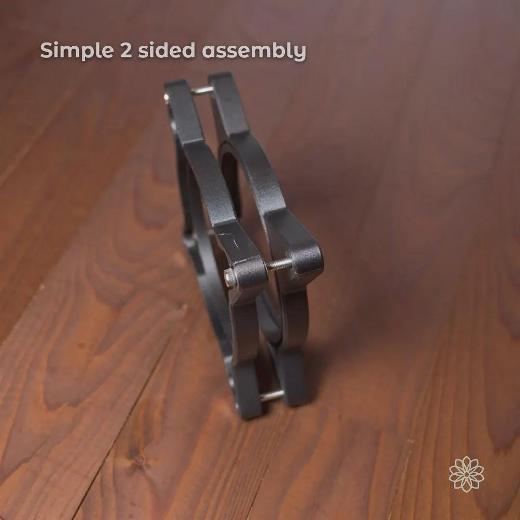 Side profile view of the Vent Link two-piece through-hull assembly bolted together, showing simple two-sided construction and alignment hardware. This image demonstrates how the adapter clamps securely through a panel or wall opening to create a stable, reversible heater duct pass-through. On-image text reads “Simple 2 sided assembly.”