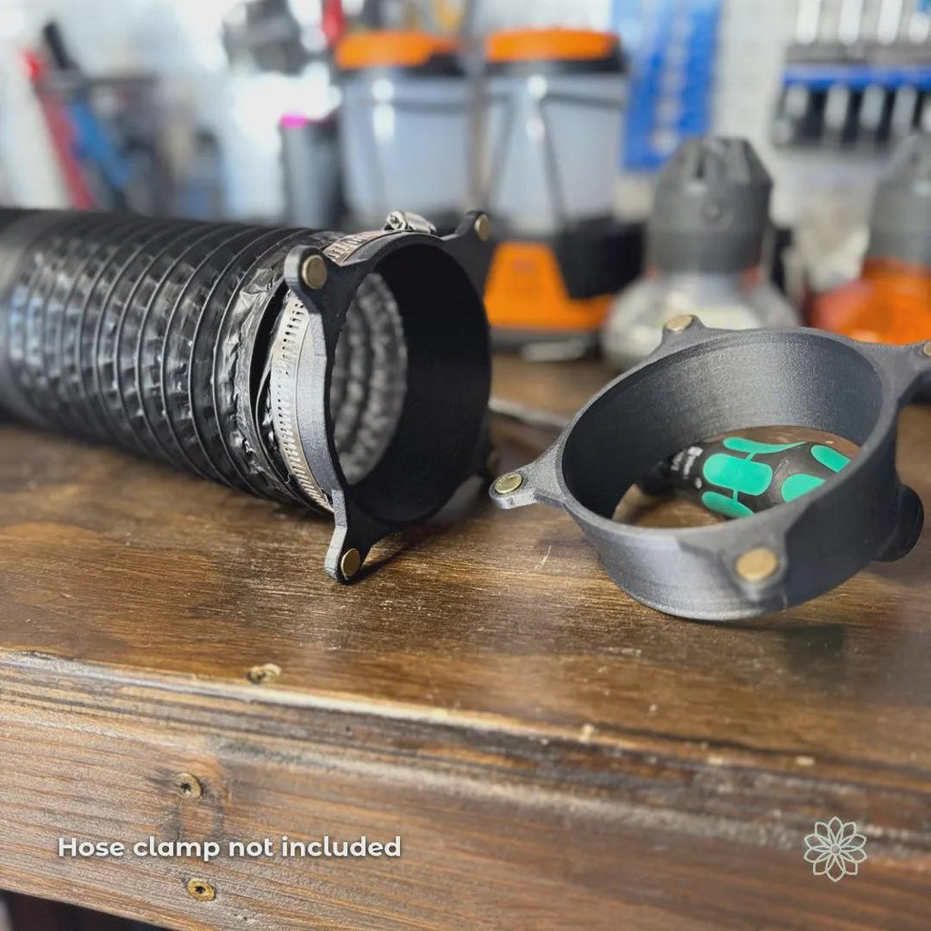 Vent Link magnetic heater adapter components shown with a 4-inch flexible heater hose on a workbench, illustrating installation context and fitment. Hose clamps are visible on the hose but are not included with purchase. This image clarifies installation requirements and compatibility for diesel heater ducting. On-image text reads “Hose clamp not included.”