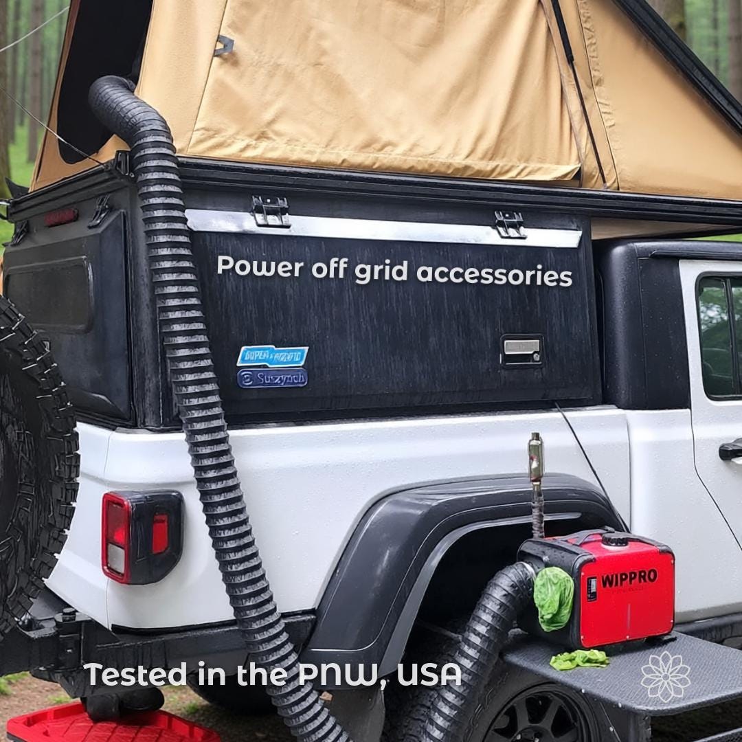 Rear view of an off-road vehicle with a camper and rooftop tent, showing a diesel heater mounted externally with ducting routed into the vehicle. The image includes the text “Power off grid accessories” and “Tested in the PNW, USA.” This scene represents real-world testing of off-grid power and heating accessories in outdoor environments.