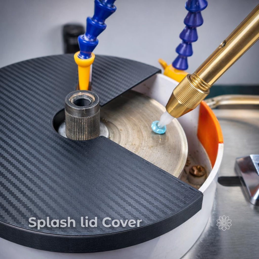 Top-down view of a faceting machine basin fitted with a dark textured splash lid covering the non-working area of the lap. On-image text reads “Splash lid Cover.” A gemstone on a dop stick is shown contacting the spinning lap while water feeds nearby, illustrating slurry containment and cleaner cutting during faceting.