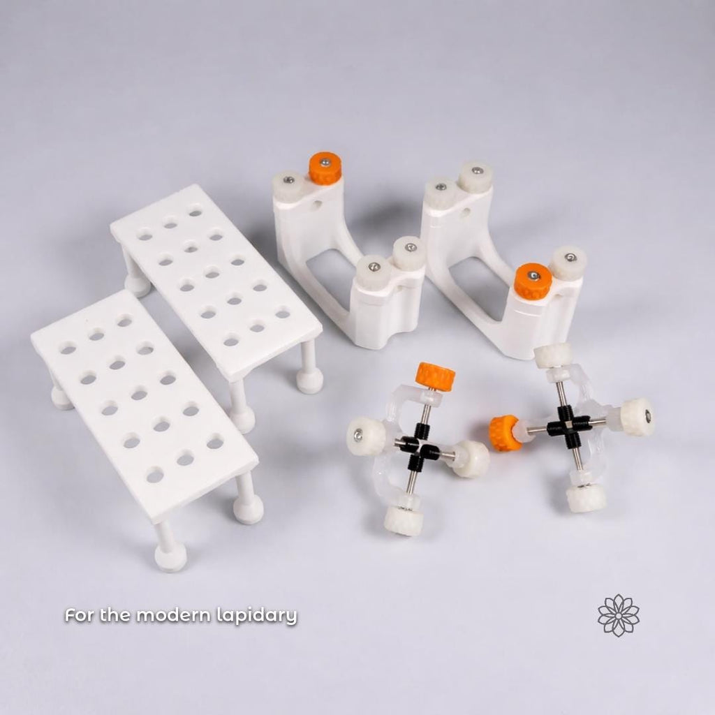 Studio photograph showing magnetic dop stick trays alongside Gem Axis alignment tools and other lapidary fixtures, with visible text reading “For the modern lapidary,” emphasizing system compatibility, modular workflow design, and professional gemstone cutting use.