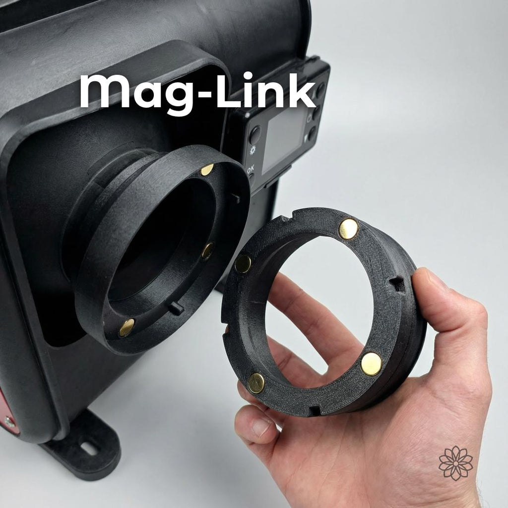 Hand holding the Mag-Link magnetic diesel heater coupler next to a heater outlet, showing quick-connect and quick-disconnect capability. Embedded magnets allow fast deployment and removal of the 4-inch hose, ideal for overland, camping, and temporary heating setups where speed and clean connections matter.