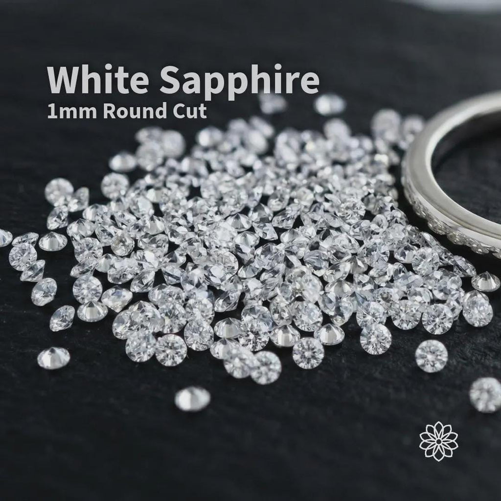 White sapphire gemstones, 1 mm round cut, loose accent stones displayed on dark velvet fabric, bright clear sparkle with uniform size, ideal for pavé settings, halo rings, and fine jewelry embellishment.