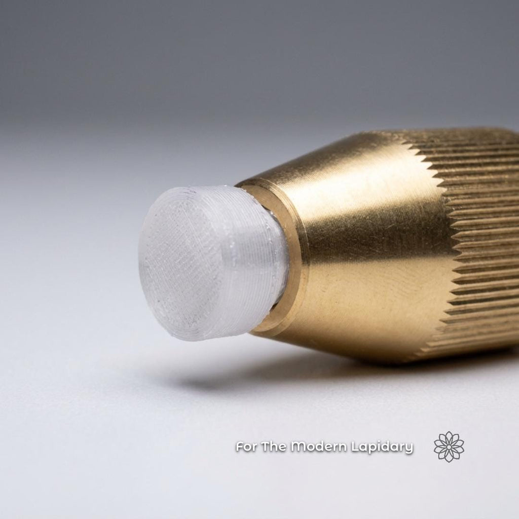 Close-up of a printed polycarbonate (pc) dop stick with white transfer or mounting material used to hold gemstones during faceting. Visible text reads “For The Modern Lapidary.”