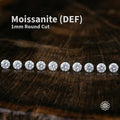 Hero image of DEF color 1 mm round cut moissanite stones arranged in a straight line on a dark wood background. The calibrated micro gemstones show bright white brilliance, high fire, and diamond-like sparkle for pavé and halo jewelry settings. Overlay text reads “Moissanite (DEF) 1mm Round Cut.” A small Aetherium floral logo appears in the lower corner.