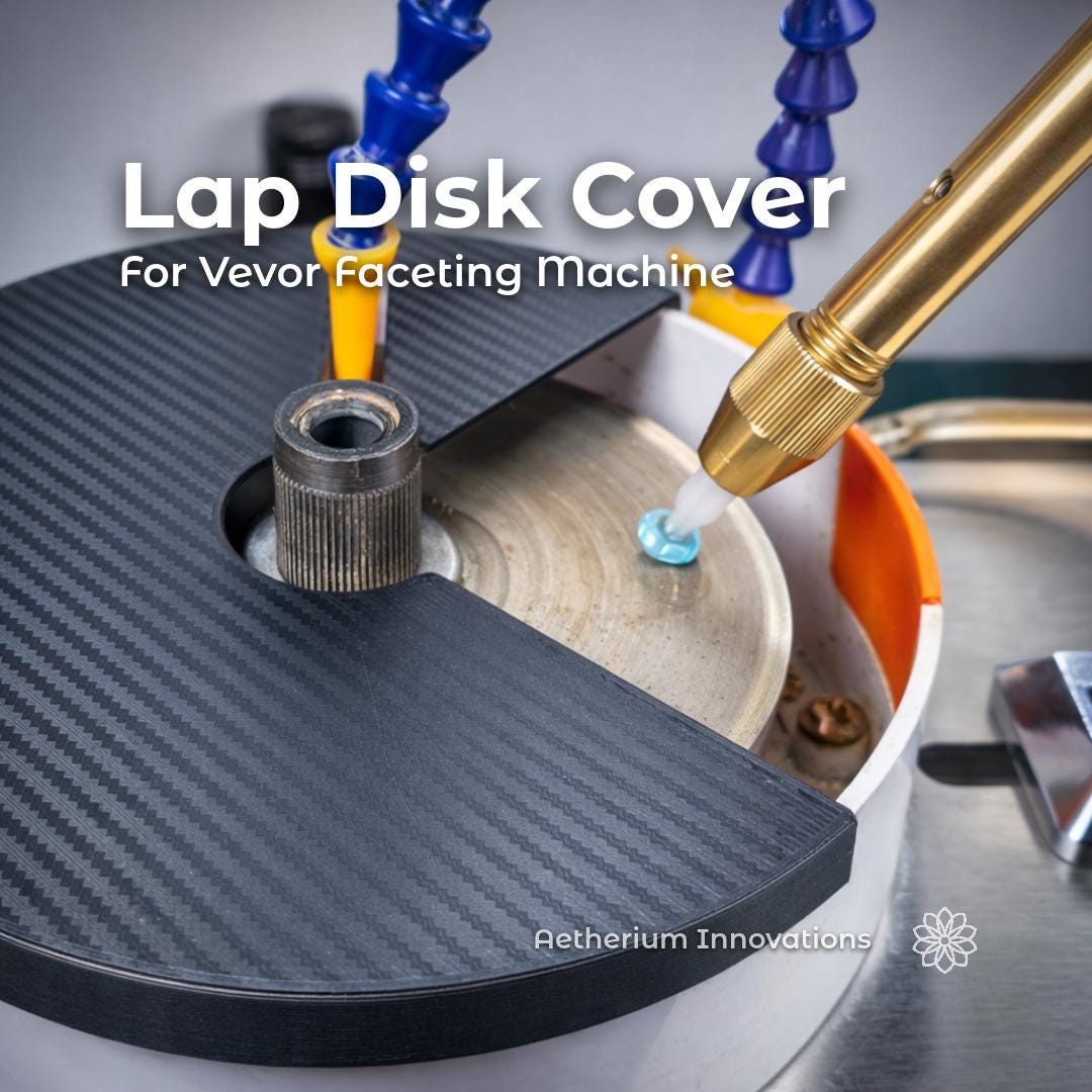 Black lap disk cover installed on a Vevor faceting machine above a spinning lap disk, with a brass faceting handpiece holding a blue gemstone on a dop. The cover shields the non-working side of the lap to help contain slurry and spray. Overlay text reads “Lap Disk Cover For Vevor Faceting machine.”