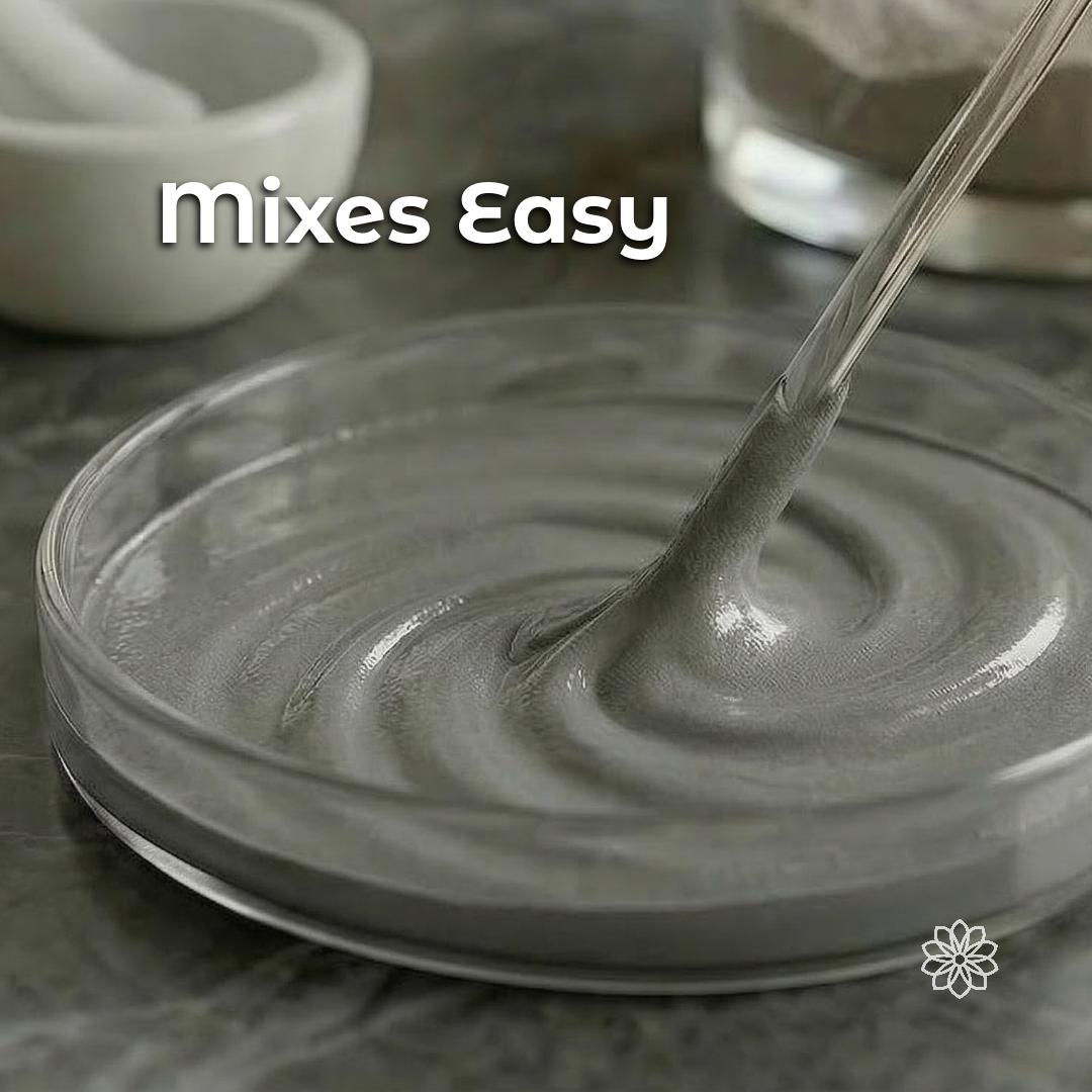 Diamond polishing powder mixed into a smooth grey slurry on a glass plate with a metal spatula, demonstrating how micron-graded diamond abrasive powder can be blended into polishing paste for lapidary work, jewelry finishing, knife stropping compound, optics polishing, and precision metal mirror finishing.