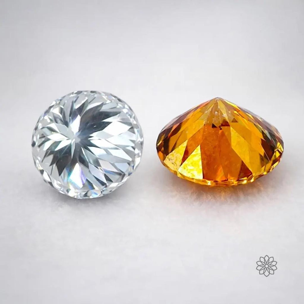 Two precision-cut gemstones displayed side by side on a neutral background, one clear round brilliant stone and one orange faceted stone, showing symmetry, facet structure, and light reflection differences used in jewelry cutting. The white stone is the moissanite in this ring.