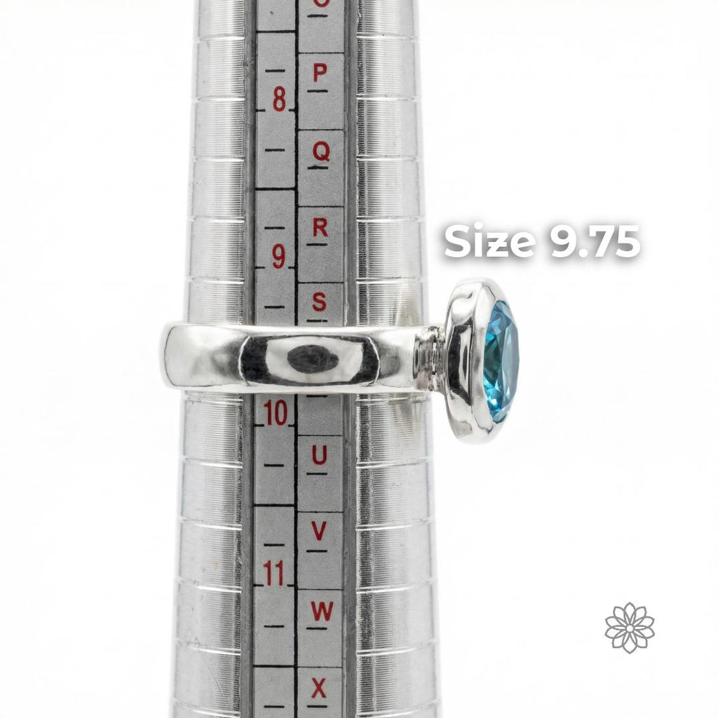 Side view of a sterling silver sapphire ring on a ring mandrel showing band thickness, bezel height, and scale. The ring is displayed at size 9.75. Visible text says “Size 9.75.”