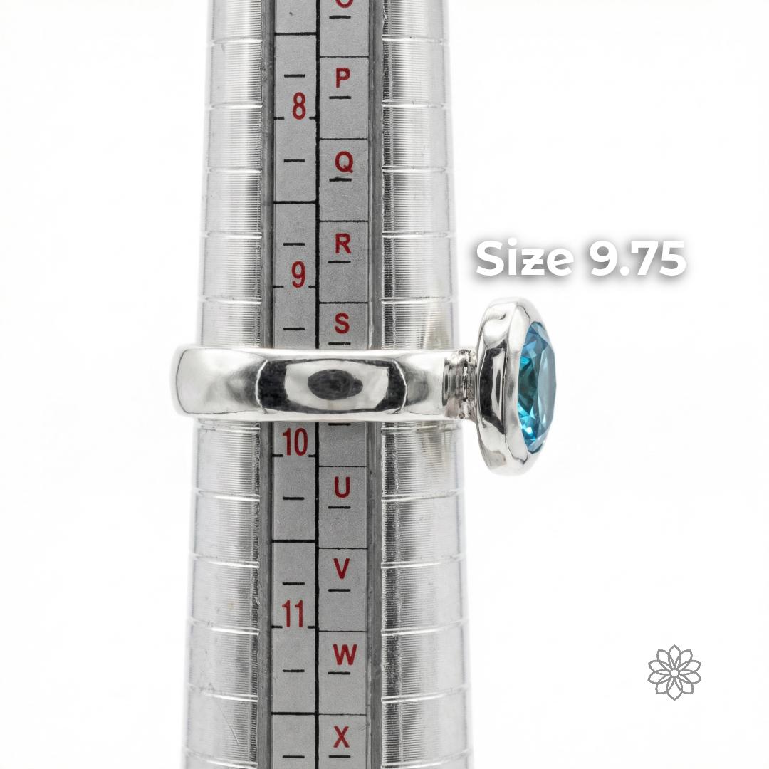 Side view of a sterling silver sapphire ring on a ring mandrel showing band thickness, bezel height, and scale. The ring is displayed at size 9.75. Visible text says “Size 9.75.”